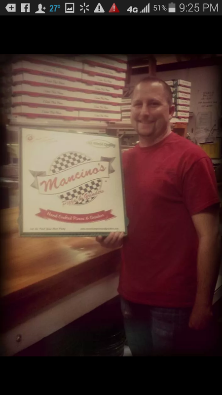Man holding Mancino's pizza box