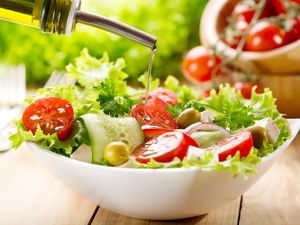 Salad with oil being poured on top